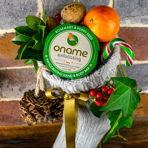Oname christmas stocking with gardeners soap, leaves, tangerine and candy cane